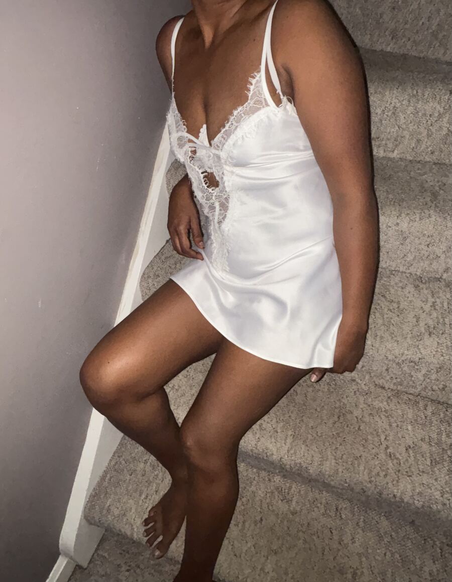 Maya, tantric massage therapist in Peterborough, wearing white satin and lace lingerie
